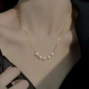 Elegant gold pearl necklace with minimalist round white pearls on a thin chain for women