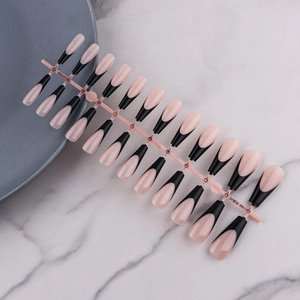 Macro shot of 24pcs nude and black French tip oval press-on nails on a pink holder