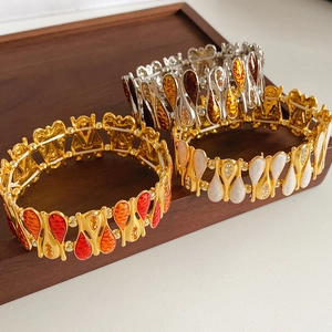 Detail of vintage-style elastic bracelets with zircon teardrops and enamel plating