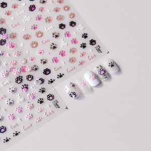 Detailed view of 3D embossed cat paw nail stickers with cute pink and black patterns