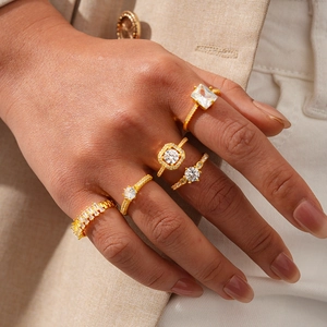Detailed view of five-piece gold plated ring set with zircon on model's hand
