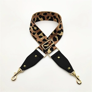 Detail of leopard print bag strap with golden buckles and leather stitch finishing