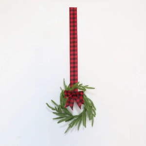Detail of Norfolk Pine PE wreath with red buffalo plaid bow and hanging ribbon decor