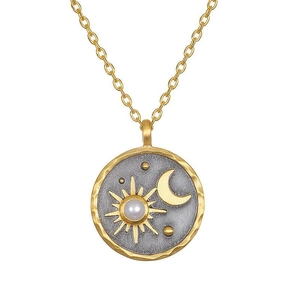Detail of vintage round sun moon pendant with star patterns and white stone inlay
