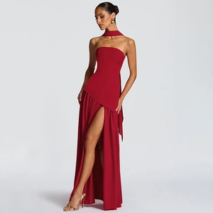 Detailed view of elegant red strapless gown featuring high slit and matching choker