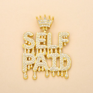 Close-up of golden hip hop crown pendant with dripping Self Paid letters and full rhinestones