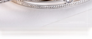 Macro detail of silver plated bangle with hand-set cubic zirconia and snap clasp