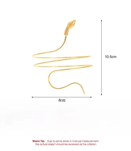 Detail view of gold snake-shaped arm cuff showing dimensions and polished alloy texture