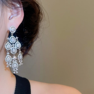 Close-up of elegant silver chandelier earrings with marquise cut cubic zirconia crystals