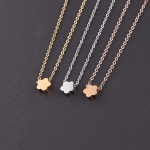 Detailed view of floral pendants in gold, silver and rose gold finishes on O-chains