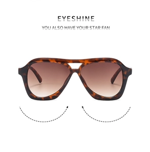 Close-up of tortoise shell aviator sunglasses with brown gradient lenses and double bridge
