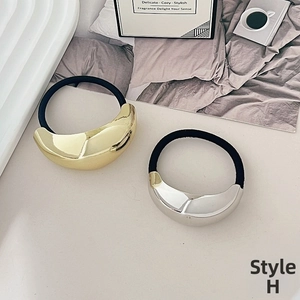 Detail view of Style H minimalist elastic hair ties with gold and silver irregular metal plates