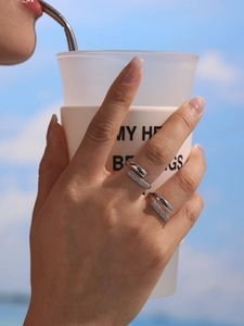 Model wearing a silver 5A zircon ring in stainless steel against a blue sky background