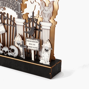 Glow-in-the-dark wooden Halloween cemetery scene ornament with ghosts and skulls