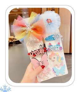 Close-up of girls Frozen themed hair clips with rainbow mesh bows and glitter icons
