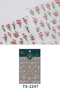 Macro detail of 3D embossed pink tulip nail art stickers with Lucky text and packaging