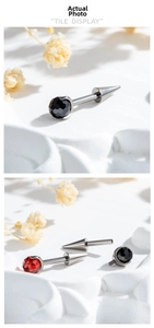 Detail view of F136 titanium threaded piercing studs with black and red faceted gems