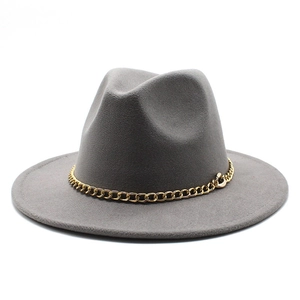 Close-up of wide brim grey fedora hat with a decorative chunky gold metal chain link