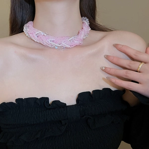 Detail of the multi-strand braided pink beads and white pearls necklace for women