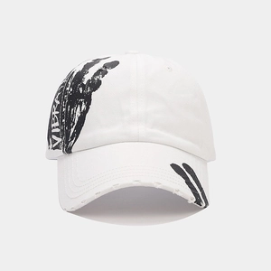 Close-up of VIBRA graffiti print and distressed brim details on a white baseball cap