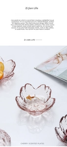 Detailed top view of pink cherry blossom glass sauce dish with textured petal edges