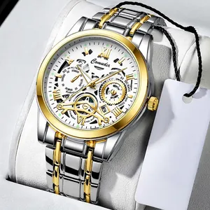 Macro shot of silver and gold stainless steel band with intricate hollow watch face