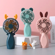 Detailed view of three colorful mini handheld fans with cute animal ear designs