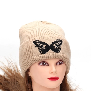 Chic beige knit beanie with black butterfly embroidery for winter warmth and comfort