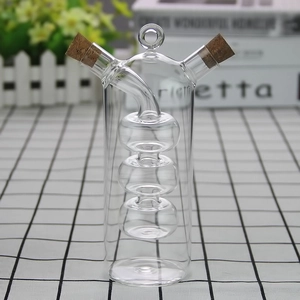 Detail of dual-spout glass oil and vinegar dispenser with decorative cork stoppers