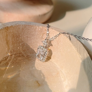 Close-up of S925 sterling silver geometric pendant with rectangular zircon on stone