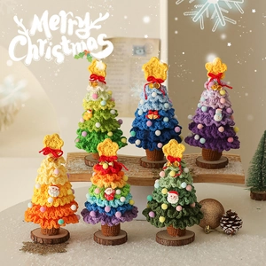Handmade crochet mini Christmas tree ornaments with colorful pom poms and wooden bases