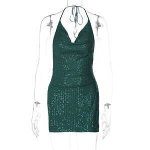 Detail view of the deep green sequin fabric and halter neck design on mini dress