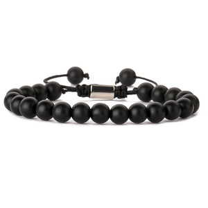 Close-up of black matte lava stone beads and stainless steel magnetic clasp with woven cord