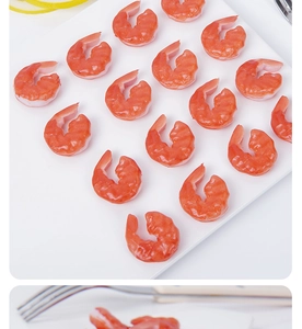 Macro detail of artificial PVC peeled shrimp models arranged neatly on white background