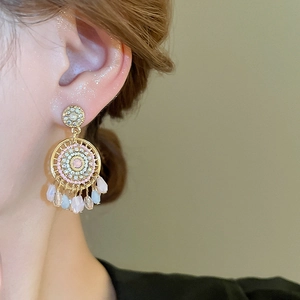 Detail of vintage bohemian tassel earrings with colorful rhinestones and teardrop beads