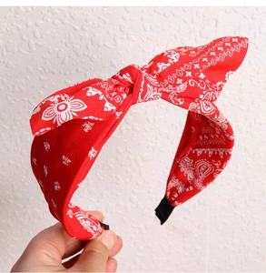 Close-up of red paisley headband with rabbit ear knot and classic floral pattern