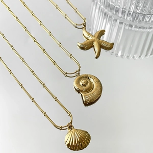 Gold plated stainless steel ocean necklaces with starfish, conch and shell pendants