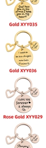 Macro view of engraved quotes on polished round gold and rose gold keychains