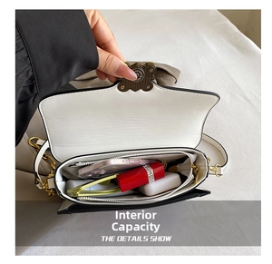 Internal view of the bicolor crossbody bag showing main compartment and zipper pocket