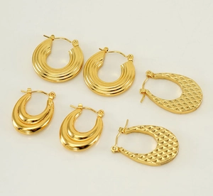 Detailed view of three pairs of 18K gold-plated stainless steel earrings with textured patterns