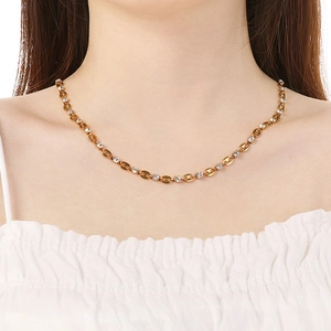 Close-up of 18K gold plated necklace with zircons worn on model neck for size view