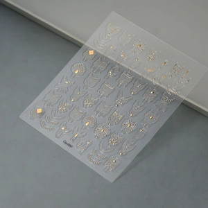 Macro detail of gold embossed 5D nail art stickers with butterfly and floral designs