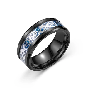 Polished black stainless steel dragon ring with silver Celtic pattern and blue glitter background