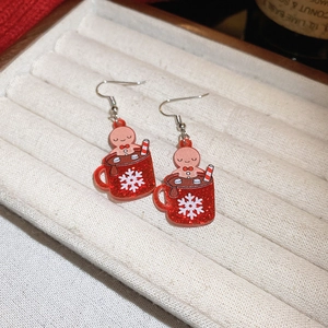 Gingerbread man in a red sequin mug earrings with white snowflake Christmas pattern