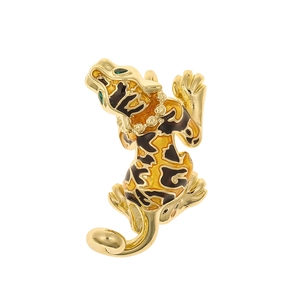 Detailed view of a golden enamel tiger pendant with green gemstone eyes and stripes