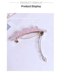 Detail shot of pink crystal hair clip with silver metal spring base on white background
