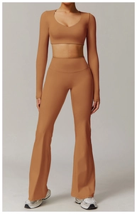 Close-up of caramel brown high-waist flared yoga pants and long sleeve crop top