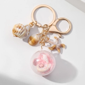 Gouden oceaan thema sleutelhanger met zeester schelp en roze glitter bol hanger