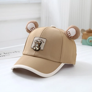 Detail of khaki kids baseball cap featuring 3D plush bear ears and outdoor wear patch