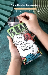 Close-up of a printed leather glasses pouch with squeeze top and vintage art design